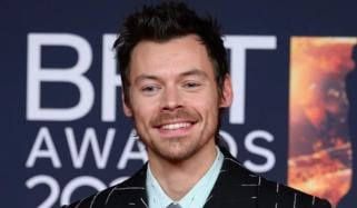 Harry Styles pokes fun at queerbaiting allegations with 'SNL' stage kiss