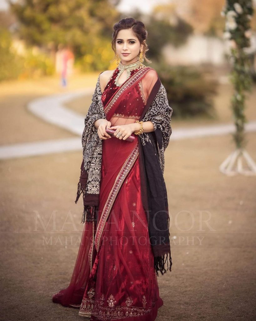 Aima Baig poses stunning looks in red saree on her sister’s wedding 