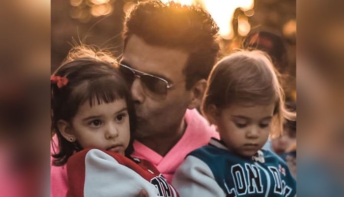 Karan Johar shares adorable pics of kids Roohi, Yash in matching rain suits