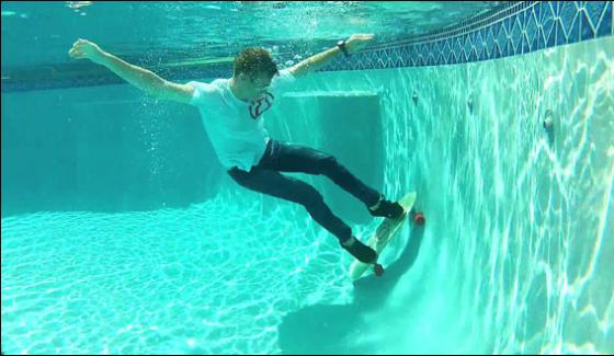 Adventurers Perform Skate Boarding Under Water At Hawaii