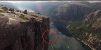 Thrillseeker Tightrope Walk Between Two Cliffs In Norway