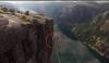 Thrillseeker Tightrope Walk Between Two Cliffs In Norway