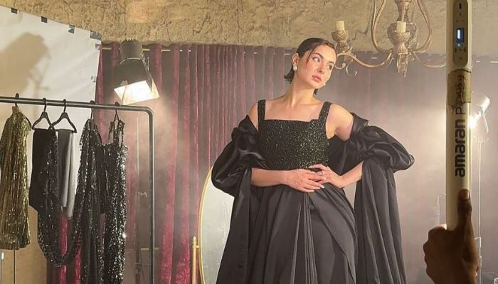 Hania Aamir is the beautiful lady in black posing for a photoshoot