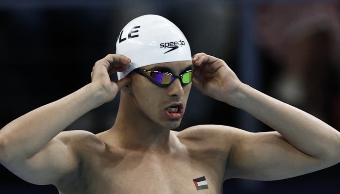 Palestinian swimmer Yazan Al Bawwab waves flag with pride at Paris Olympics