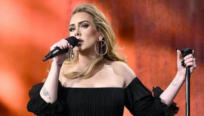 Adele nearly suffered wardrobe malfunction due to torrential downpour