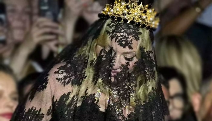 Madonna makes regal entrance in head-to-toe veil at Milan Fashion Week