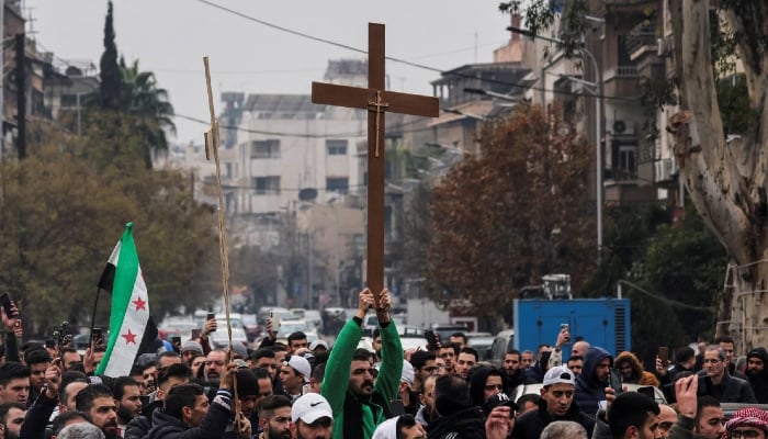 Syrian Christians protested after a Christmas tree was set on fire in Suqaylabiyah