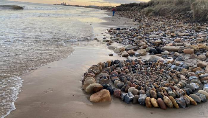 Mysterious artist behind stunning beach stone art finally revealed