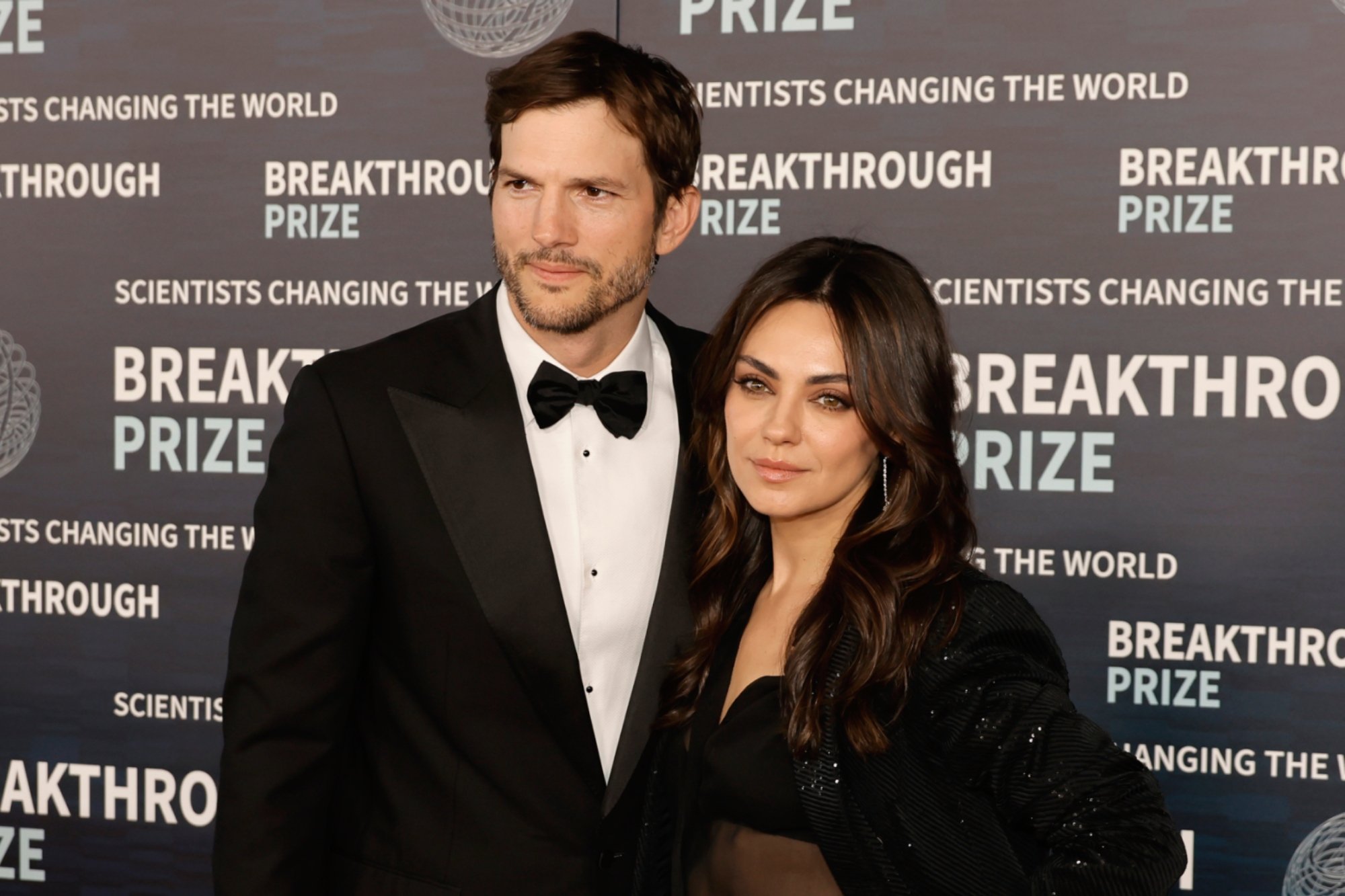 Ashton Kutcher, Mila Kunis show off their romance at Backstreet Boys concert
