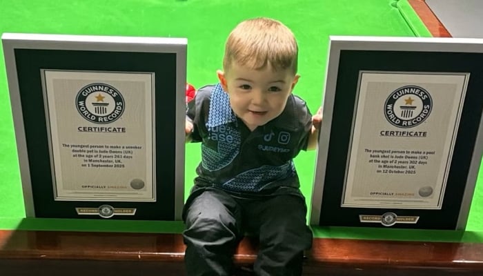 Two-year-old snooker prodigy sets world records for trick shots