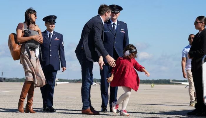 Shocking moment Usha Vance nearly falls exiting helicopter holding baby