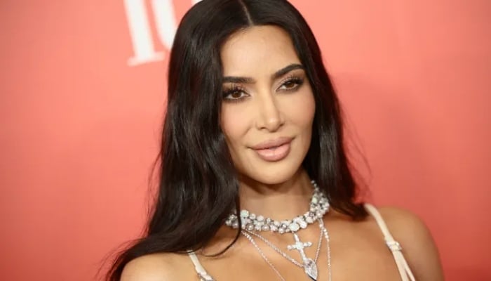 Kim Kardashian shows how to style a bold pink dress for high-profile sporting event